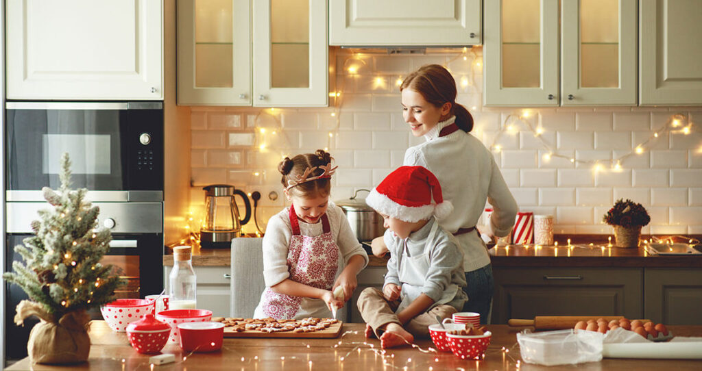 happy family mother and children bake christmas cookies