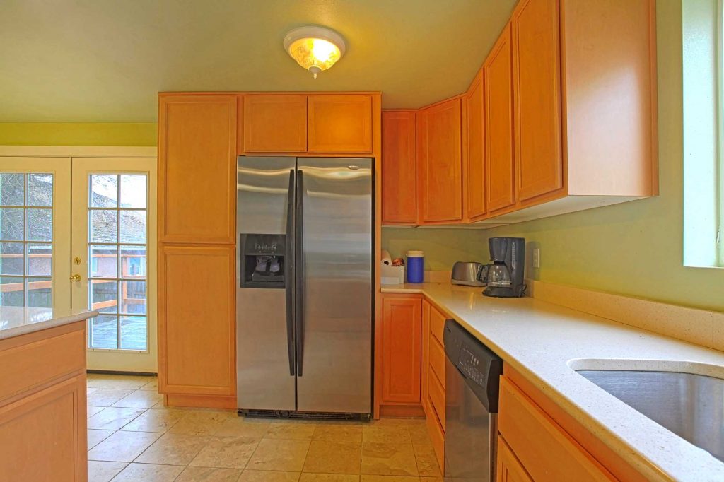 modern kitchen and cabinets with orange color tints